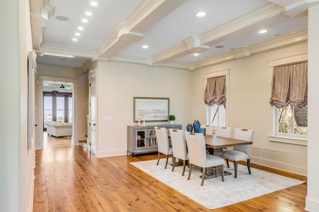 dining room featuring light hardwood / wood-style flooring, ornamental molding, and beam ceiling