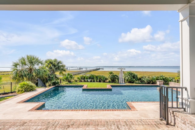 view of pool featuring a patio area and a water view