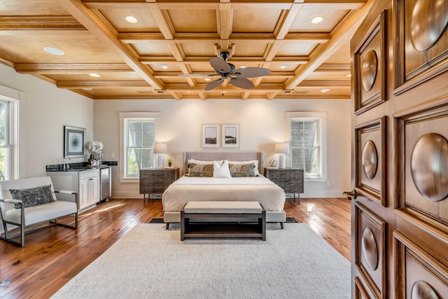 bedroom featuring hardwood / wood-style floors, multiple windows, and coffered ceiling