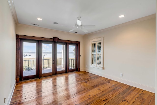 empty room featuring french doors, ceiling fan, ornamental molding, and light hardwood / wood-style flooring