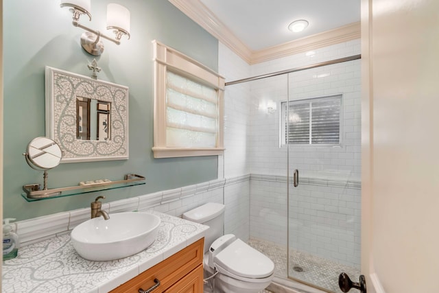 bathroom featuring toilet, vanity, ornamental molding, tile walls, and walk in shower