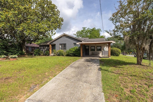 5065 Durant Ave, North Charleston, SC 29405 - view of front of house featuring driveway, an attached carport, and a front lawn