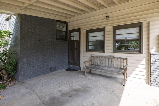 5065 Durant Ave, North Charleston, SC 29405 - doorway to property with brick siding and a patio area