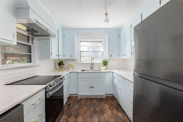 5065 Durant Ave, North Charleston, SC 29405 - kitchen with freestanding refrigerator, electric stove, custom exhaust hood, decorative backsplash, and dark stone finish floors