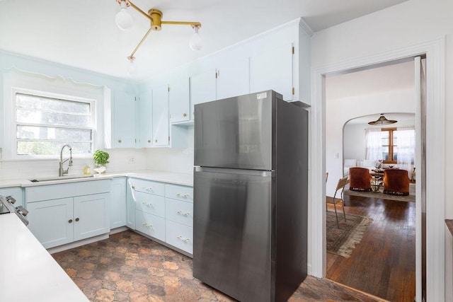 5065 Durant Ave, North Charleston, SC 29405 - kitchen with stainless steel appliances, light countertops, white cabinetry, and backsplash