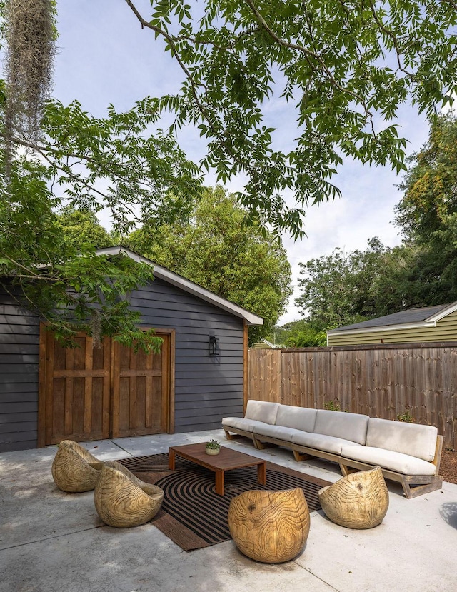 5065 Durant Ave, North Charleston, SC 29405 - fenced backyard with an outdoor living space, a patio, and an outdoor structure