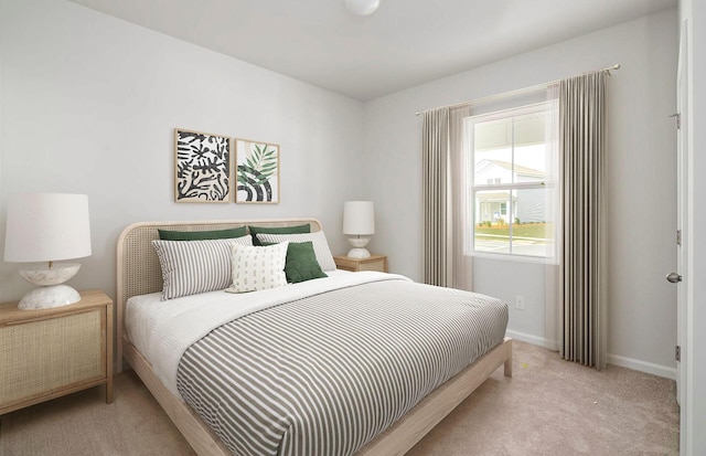 bedroom featuring baseboards and carpet