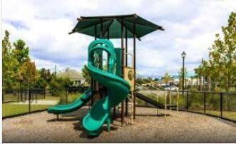 communal playground featuring fence