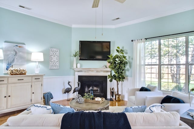 6159 Fieldstone Cir, Charleston, SC 29414 - living room featuring light wood-type flooring, wainscoting, crown molding, a fireplace, and a ceiling fan