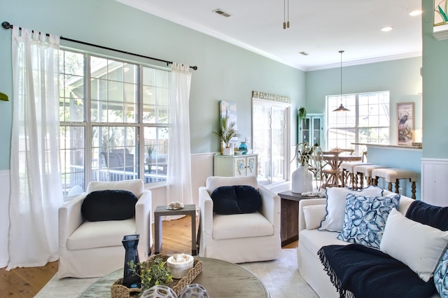 6159 Fieldstone Cir, Charleston, SC 29414 - living room with healthy amount of natural light, light wood finished floors, ornamental molding, and wainscoting