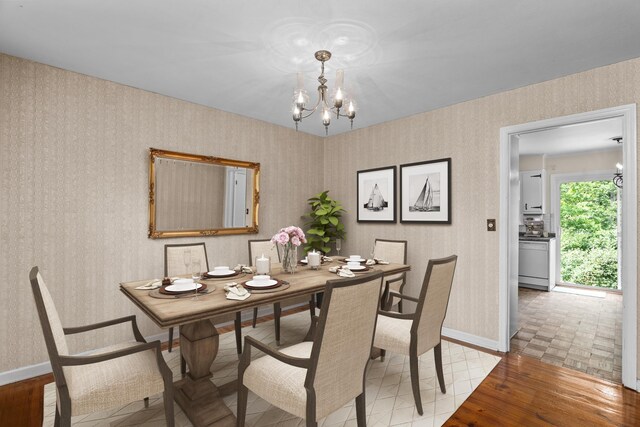 1019 Pinon Rd, North Augusta, SC 29841 - dining room with a chandelier, wallpapered walls, and light wood-type flooring