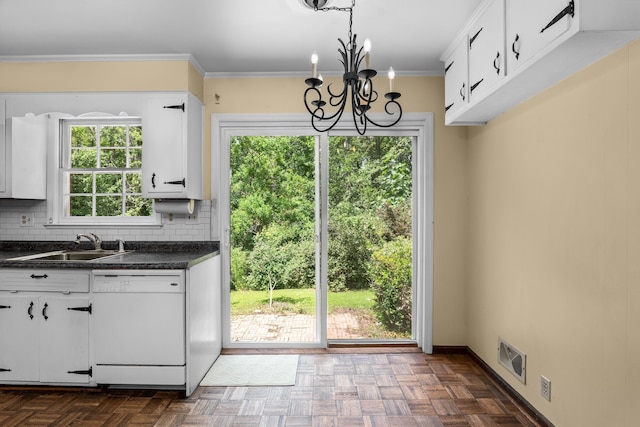 1019 Pinon Rd, North Augusta, SC 29841 - kitchen featuring dishwasher, dark countertops, a chandelier, decorative backsplash, and white cabinetry