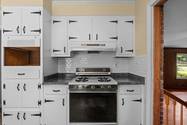 1019 Pinon Rd, North Augusta, SC 29841 - kitchen featuring gas range oven, under cabinet range hood, dark countertops, and white cabinetry