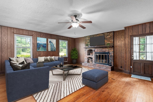 1019 Pinon Rd, North Augusta, SC 29841 - living area with a ceiling fan, healthy amount of natural light, wood finished floors, a brick fireplace, and a textured ceiling