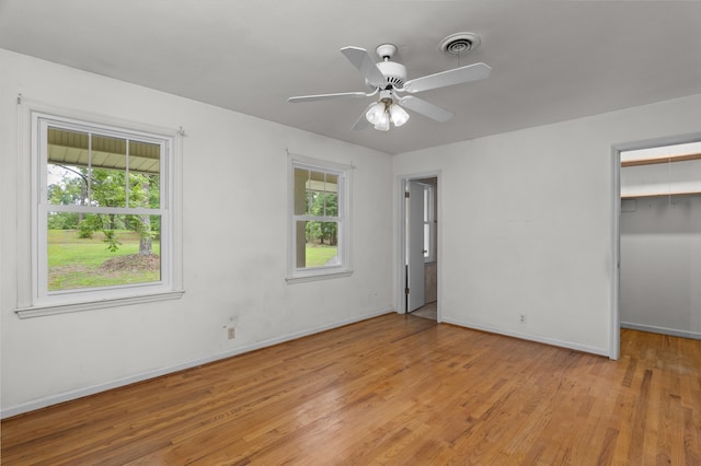 1019 Pinon Rd, North Augusta, SC 29841 - unfurnished bedroom with light wood-style flooring, a spacious closet, ceiling fan, and a closet