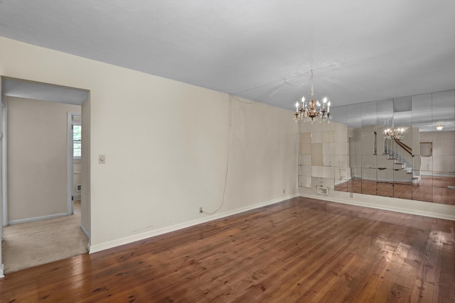 1019 Pinon Rd, North Augusta, SC 29841 - unfurnished living room with a chandelier, wood finished floors, and stairway