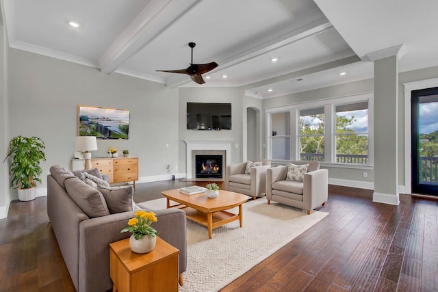 living room featuring beamed ceiling, ceiling fan, dark hardwood / wood-style flooring, and ornamental molding