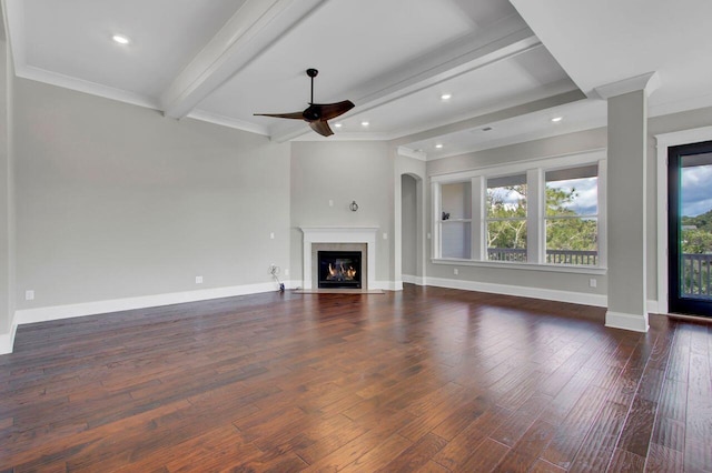 unfurnished living room with ceiling fan, beamed ceiling, dark hardwood / wood-style floors, and ornamental molding