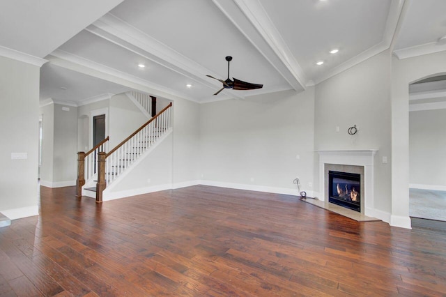 unfurnished living room featuring beam ceiling, a premium fireplace, crown molding, and ceiling fan