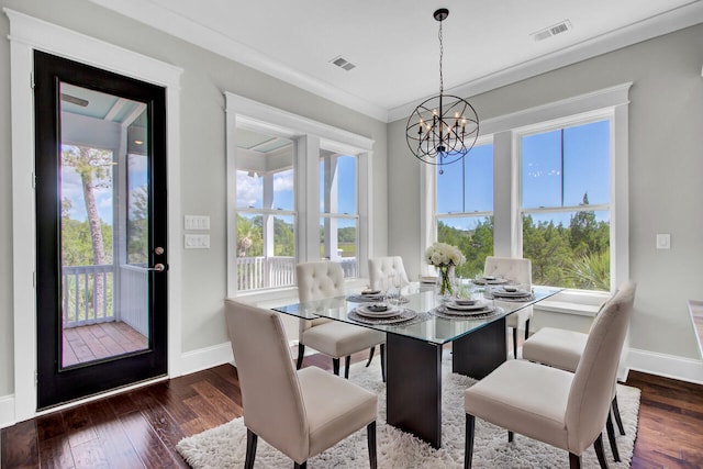 dining area featuring a chandelier, dark hardwood / wood-style flooring, plenty of natural light, and ornamental molding