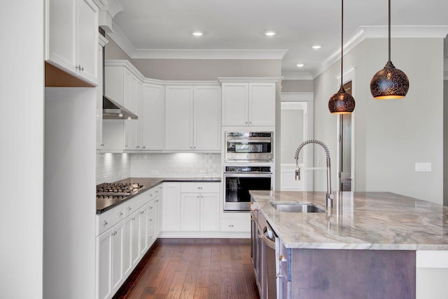 kitchen featuring pendant lighting, white cabinetry, sink, and dark stone counters