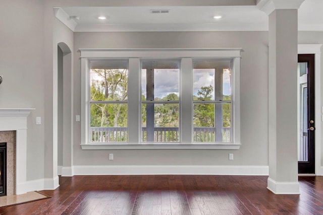 unfurnished living room with dark hardwood / wood-style floors and crown molding