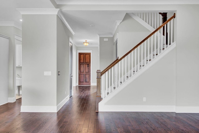 foyer entrance featuring crown molding and dark hardwood / wood-style floors