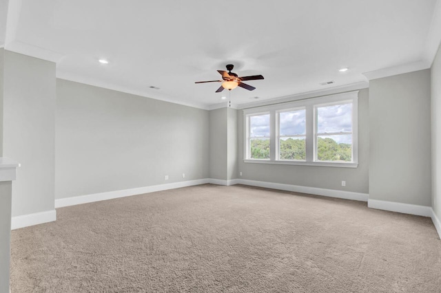 spare room featuring carpet flooring, ceiling fan, and ornamental molding