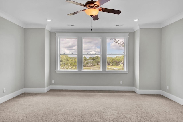 unfurnished room with carpet floors, ceiling fan, and crown molding