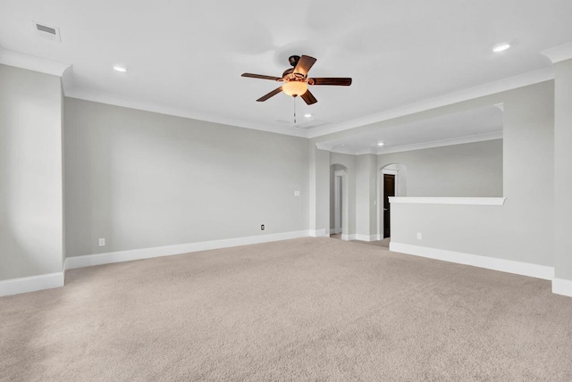 empty room featuring ceiling fan, light carpet, and ornamental molding