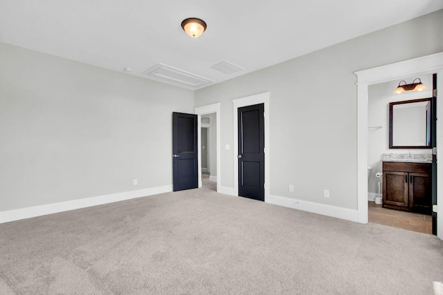 unfurnished bedroom with light colored carpet and ensuite bath