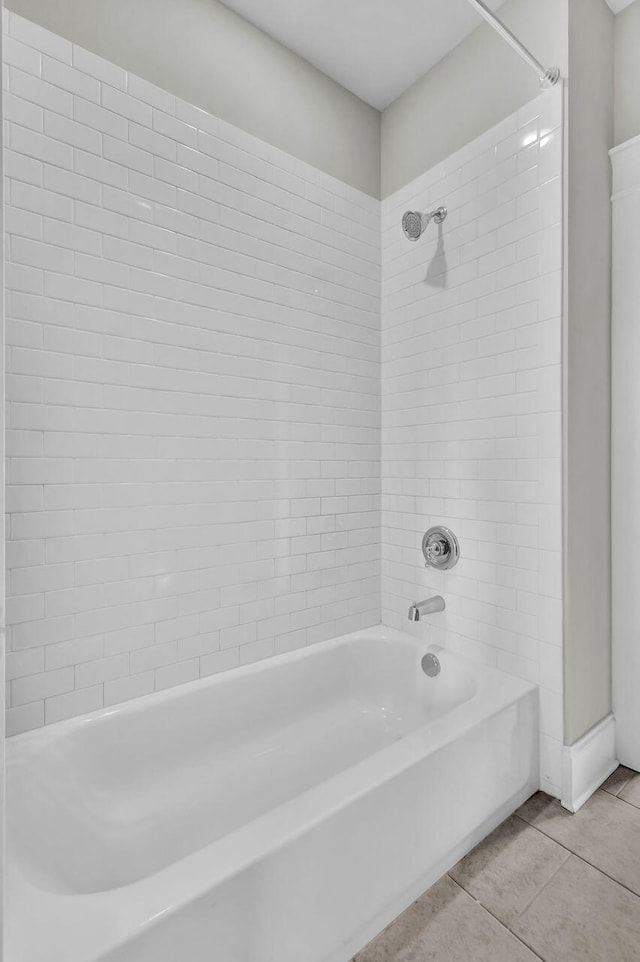 bathroom featuring tile patterned flooring and tiled shower / bath