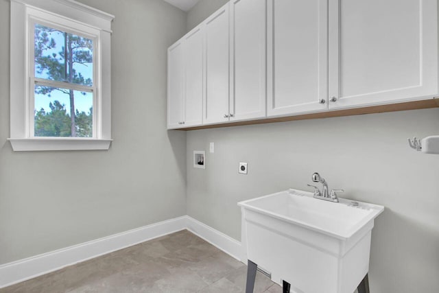 laundry room featuring hookup for an electric dryer, a wealth of natural light, cabinets, and hookup for a washing machine