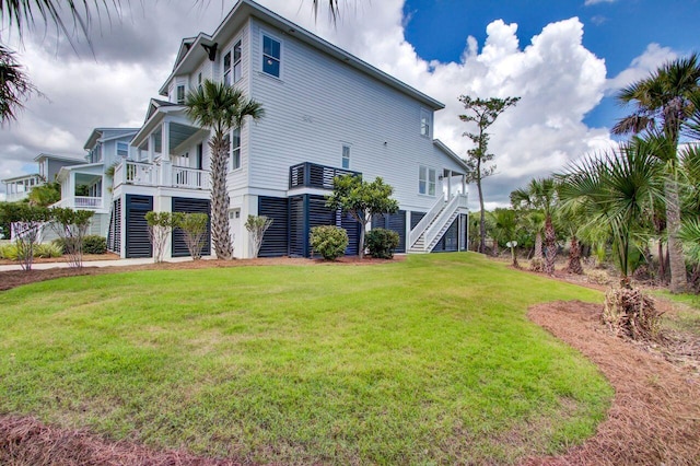 back of property with a lawn and a porch