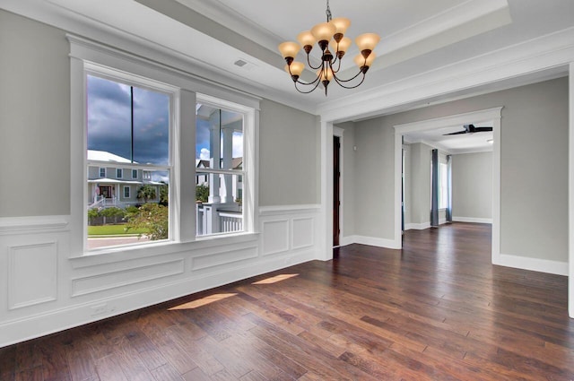 empty room with a tray ceiling and ornamental molding