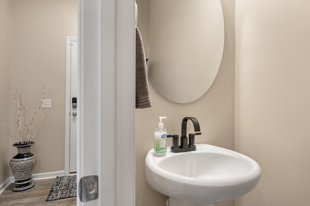 bathroom with wood-type flooring and sink