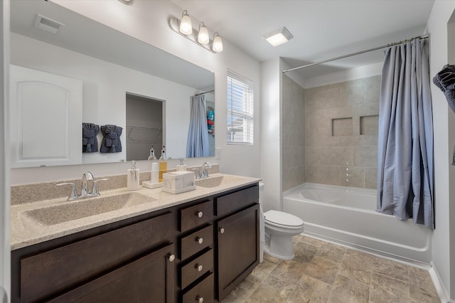 full bathroom with shower / bathtub combination with curtain, vanity, and toilet