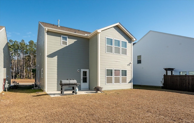 rear view of house featuring a patio area and a lawn