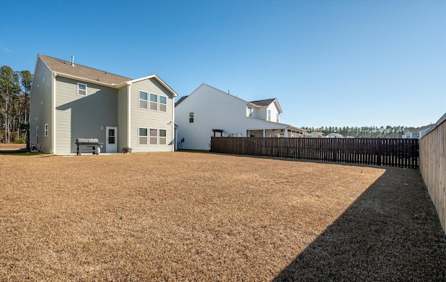 rear view of house with a yard