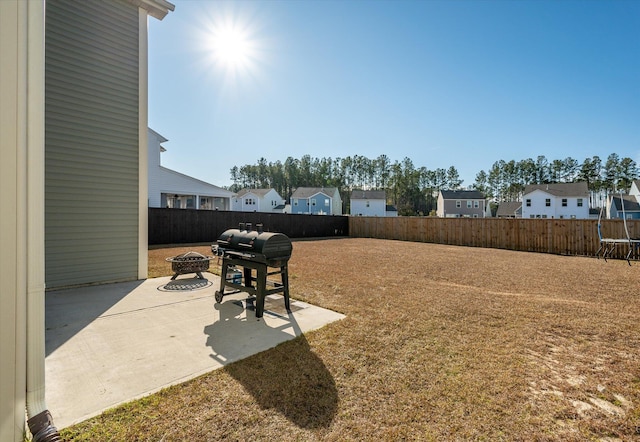 view of yard featuring a patio and an outdoor fire pit