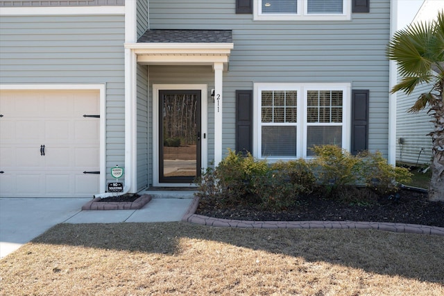 doorway to property with a garage