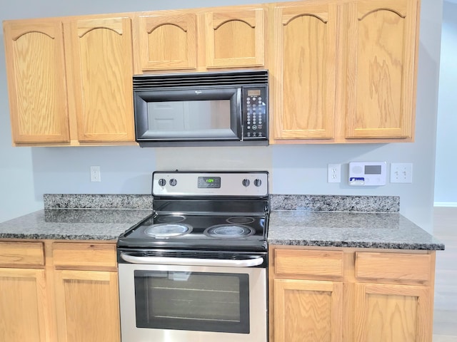 kitchen with light brown cabinetry and stainless steel range with electric stovetop