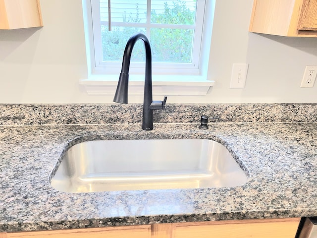 details featuring sink and light brown cabinetry