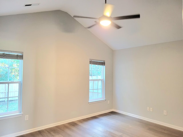 unfurnished room with ceiling fan, wood-type flooring, and lofted ceiling