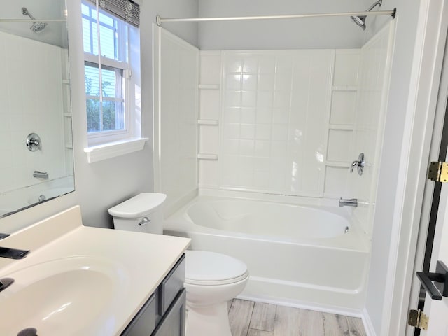 full bathroom featuring vanity, toilet, wood-type flooring, and washtub / shower combination