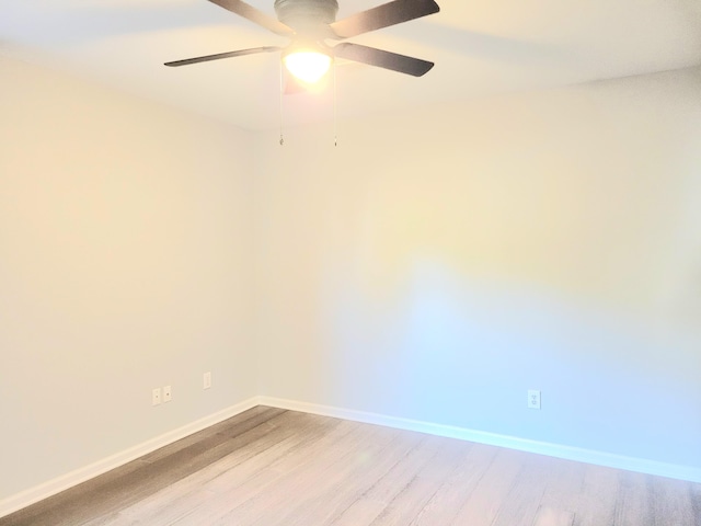 spare room featuring ceiling fan and light wood-type flooring