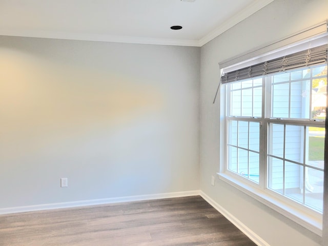 unfurnished room featuring wood-type flooring and ornamental molding