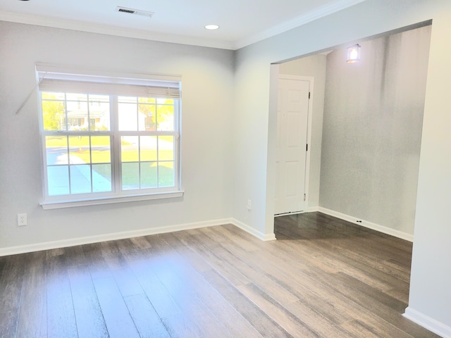 unfurnished room featuring hardwood / wood-style floors and crown molding