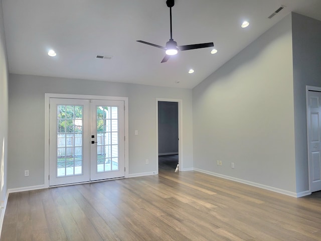 unfurnished room featuring french doors, light hardwood / wood-style floors, vaulted ceiling, and ceiling fan