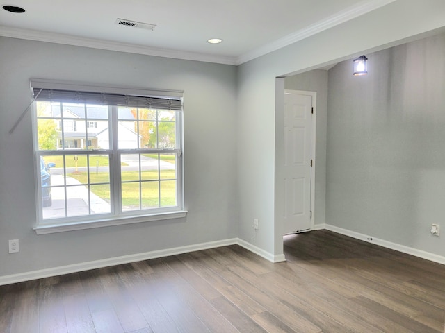 empty room with hardwood / wood-style floors and ornamental molding